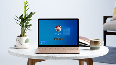 A Surface device on a table with Windows 10 Pro on screen..