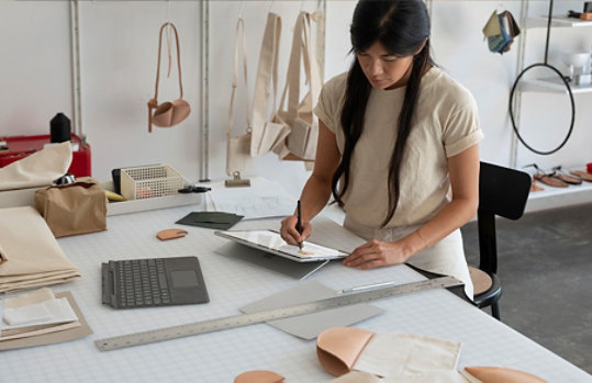 A woman using Surface Pro X.