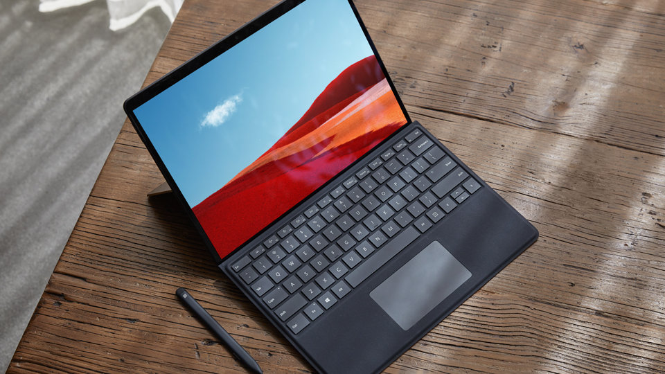 Surface Pro X in laptop mode with keyboard attached.