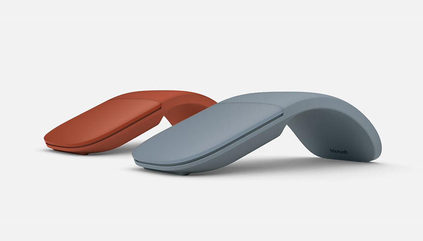 Two Surface Arc Mouse devices in Ice blue and poppy red.