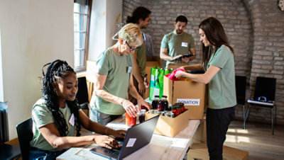A group of nonprofit workers sorting donation materials.