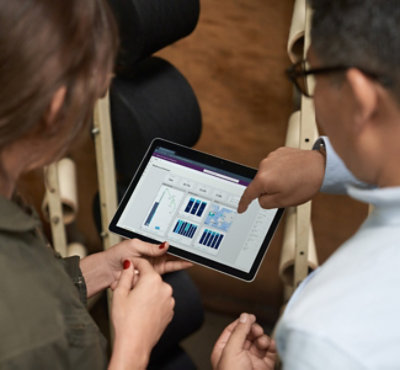 Two person's looking at a tablet