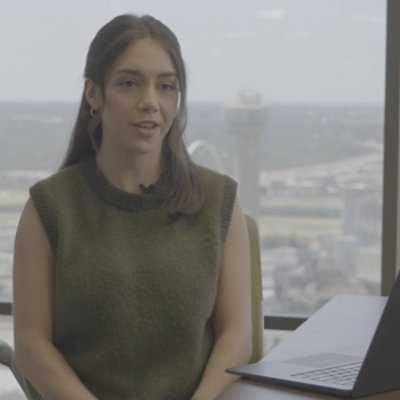 Woman in office talking to inteviewer.