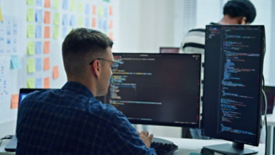 A man working on the screens in an office setup