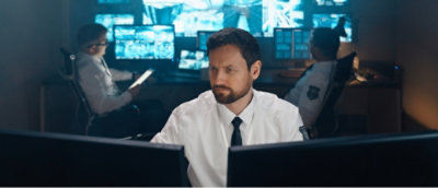 A man looking at the computer screens