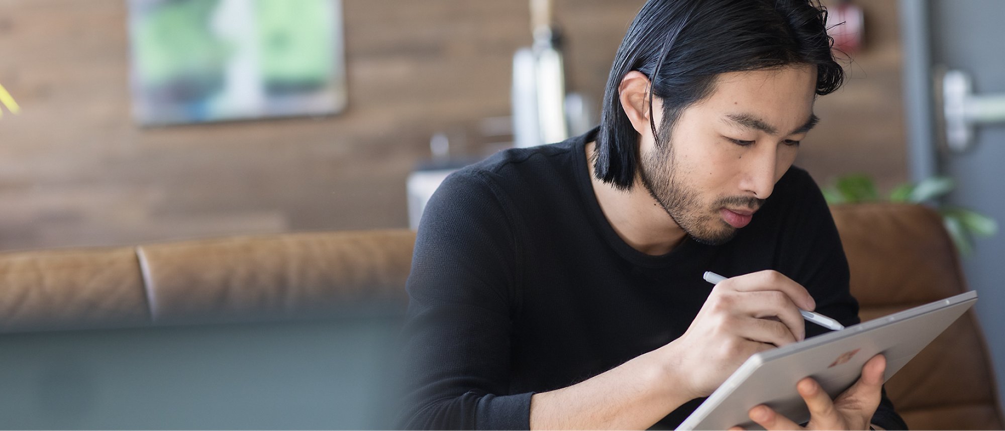 A person using stylus with his surface pro