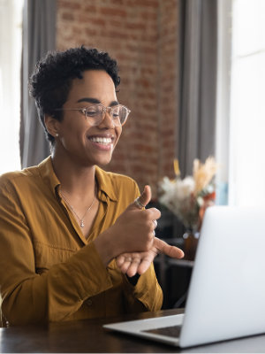 A woman sitting at a desk with a laptop.