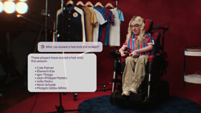A fan sitting on a chair viewing hat-trick stats.