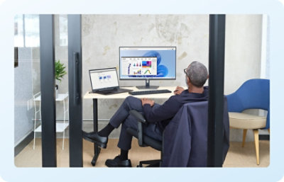 A person sitting at a desk using a Desktop.