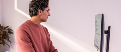 A man wearing a red shirt and glasses.