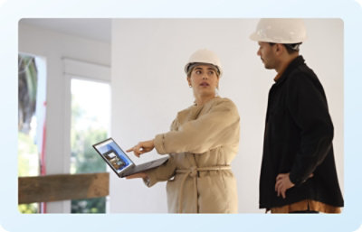 Two People discussing plans while viewing a laptop.