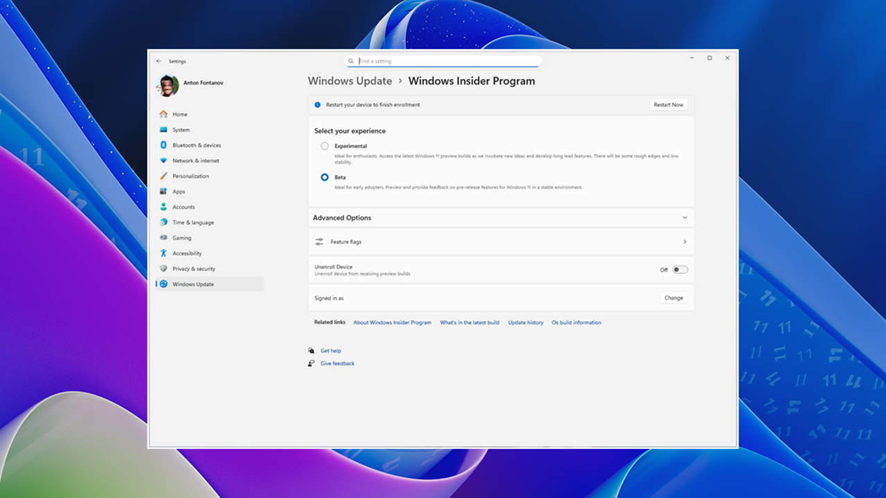 New Windows Insider Program settings on top of the desktop background with the dark blue, purple and green Windows 11 Bloom waves.
