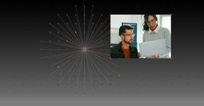A man and woman looking at a laptop.