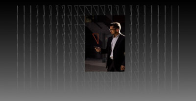 A man in a suit holding a phone.