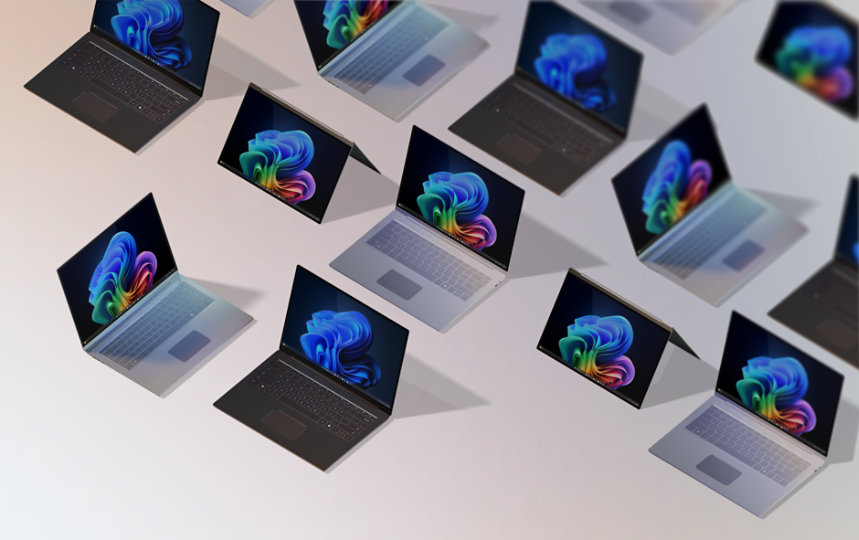 Um grupo de 12 PCs Windows 11 Pro e PCs Windows para empresas, todos abertos, vistos de cima sobre um fundo pêssego em degradê, alguns exibindo a imagem rainbow bloom e outros exibindo a imagem blue rainbow