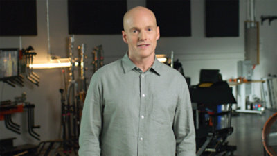Man smiling and standing amongst film production equipment