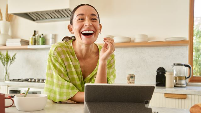 Woman in kitchen with a Windows PC.