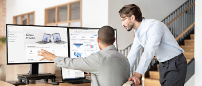 A man pointing at a computer screen.