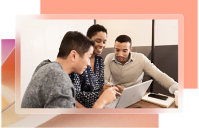 A group of people looking at a laptop.