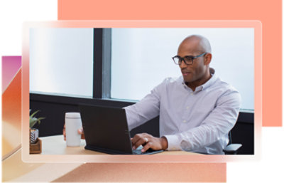 a man sitting at a desk using a laptop