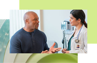 A woman in blue scrubs writing on a transparent screen.