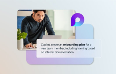 A person working on a laptop with text on the screen that reads, Copilot, create an onboarding plan for a new team member, including training based on internal documentation.