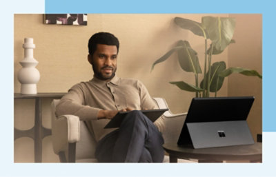 A man sitting in a chair with his legs crossed.