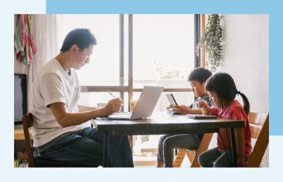 A man and children sitting at a table.