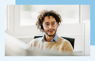 A man with curly hair wearing a headset.