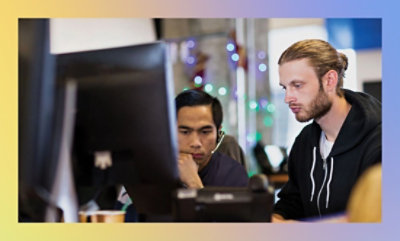 People working at computers in an office environment.