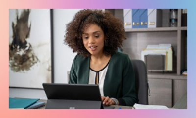 Person working on a laptop in an office setting.