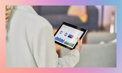 Person holding a tablet displaying graphs and analytics.