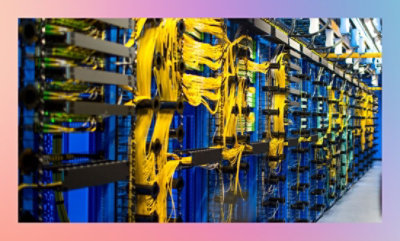 A network server room with rows of equipment and organized yellow cable management.