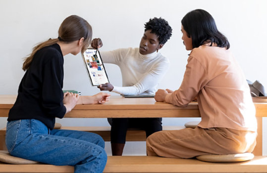 Surface Pro 8 being used in a group setting to share work.
