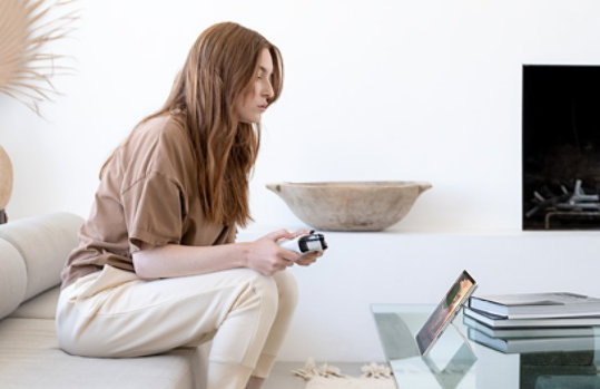 A person using a Xbox controller with the Surface Pro 8.