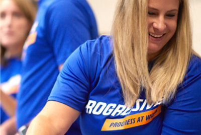 People in Progressive Insurance shirts smiling