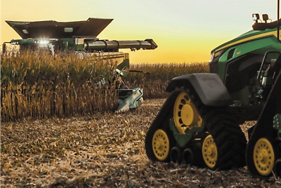 John Deere vehicles working in a field