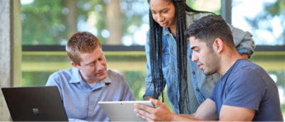 A group of people looking at a tablet
