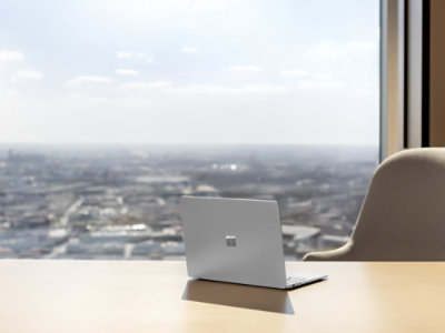 A Platinum Surface Laptop sitting open on desk.
