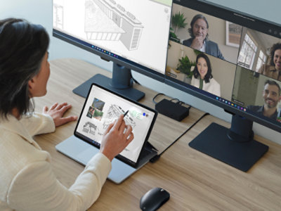 A person using a Surface Slim Pen while working on a Surface Laptop Studio.