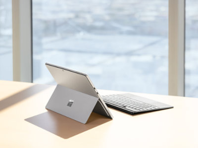 A Platinum Surface Pro sitting open on a desk with detached Pro Flex Keyboard.