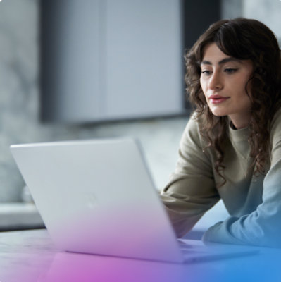 Woman uses a laptop in a bright indoor setting
