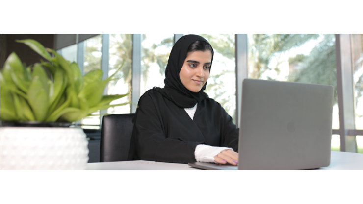 A female justice worker is typing on her laptop