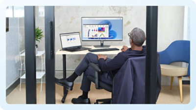 A man sitting at a desk with a computer.