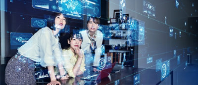 A group of people looking at a screen