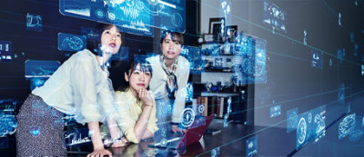 Three people engage with virtual data and holographic interfaces at a desk in a high-tech environment.