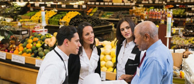 A group of people in a grocery store.
