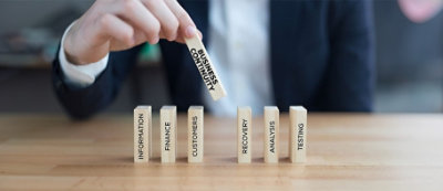 A person holding a block of wood