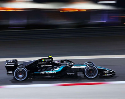 Mercedes Formula 1 race car speeding on track with motion blur background