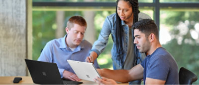 A group of people looking at a tablet